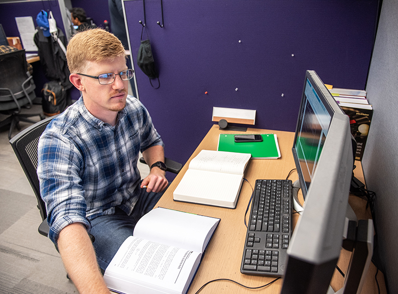 Graduate student working at a computer